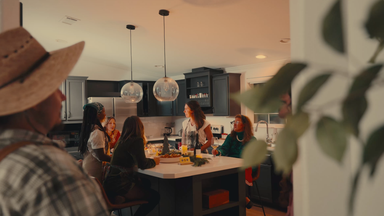 Friends around a kitchen table at a holiday gathering