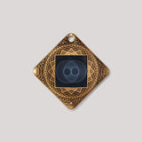 Lifetune Flex EMF protection pendant with gold geometric design on white background