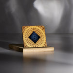 Lifetune Zone EMF protection device on a wooden stand, showcasing intricate design and central resonator pattern.