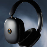 Lifetune One sticker placed on wireless headphones for EMF protection during listening sessions