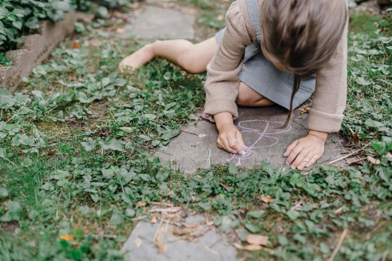 A girl drawing with chalk