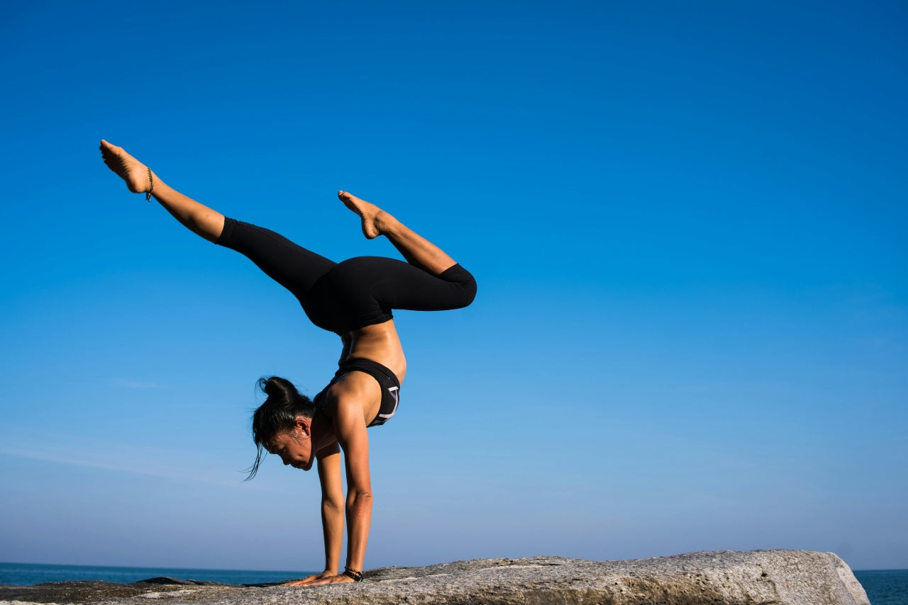 Woman doing handstand outdoors