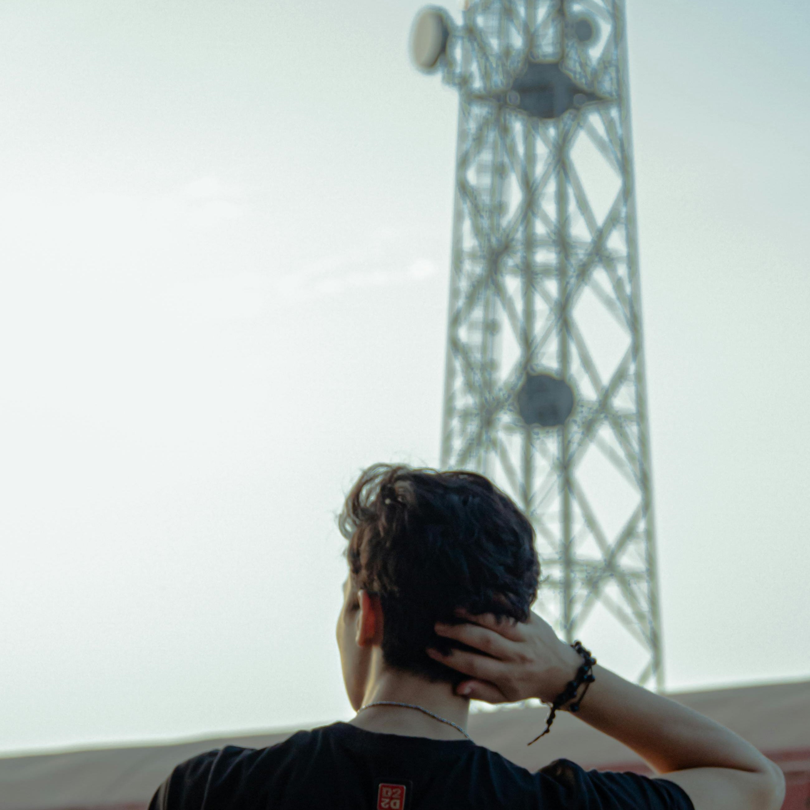 Man in front of cell tower