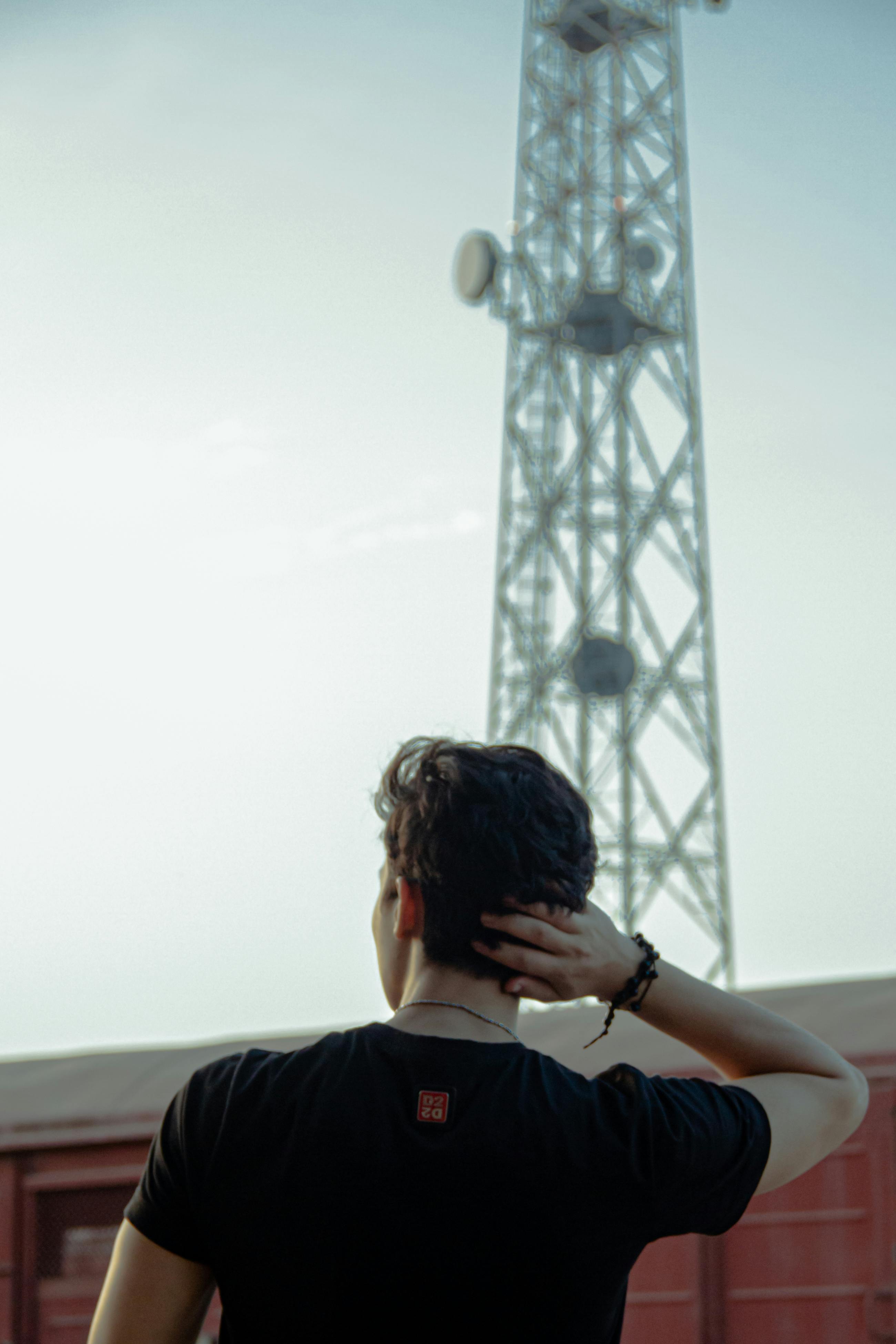 Man in front of cell tower