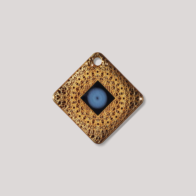 Lifetune Go EMF protection device with intricate gold design and central resonator pattern.